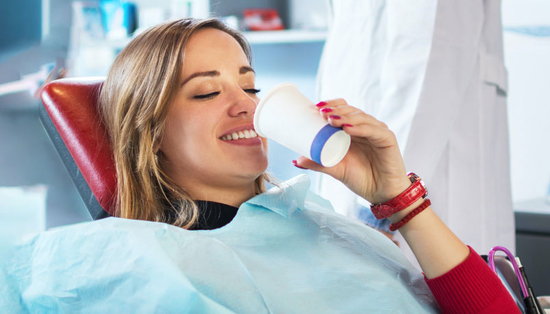 Lady smiles and having oral-sedation treatment